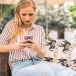 young-woman-texting-messages-smartphone-sitting-outdoor-with-coffee-book_23-2147862845